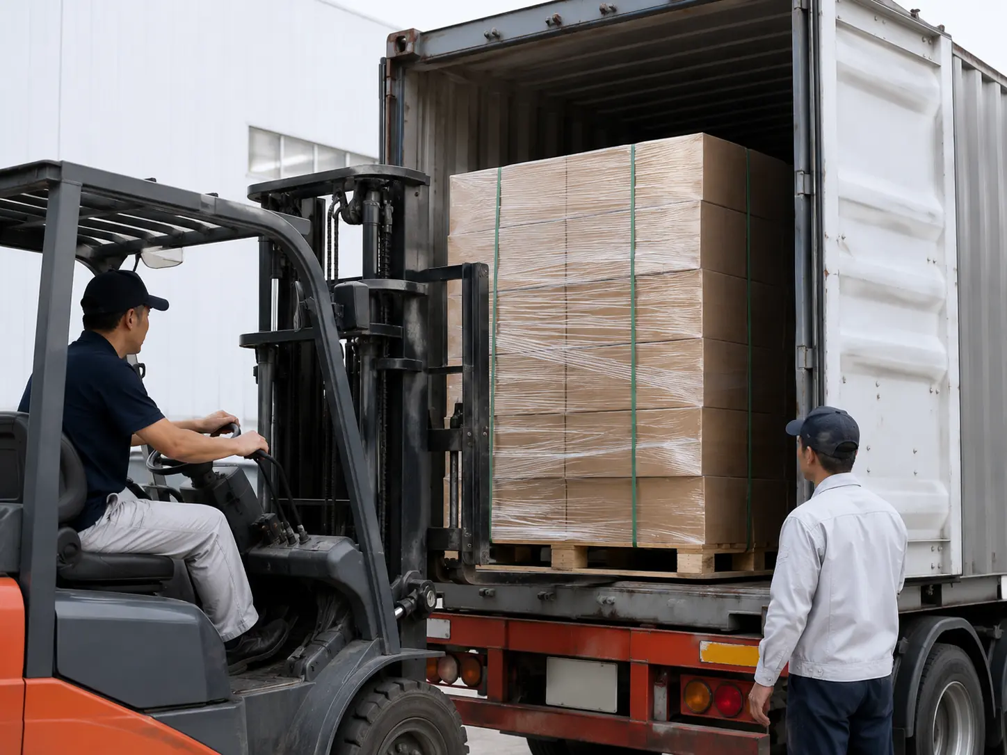 Forklift loading export-ready e-commerce packaging cartons.