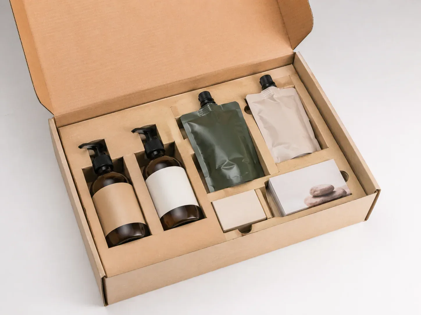 Multi-SKU bundle arranged in a repeatable compartmented paperboard insert.