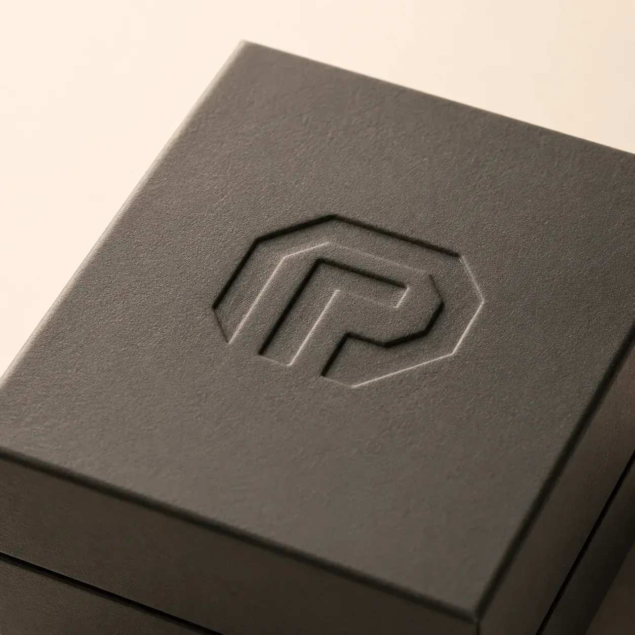 Debossed brand mark on electronics packaging